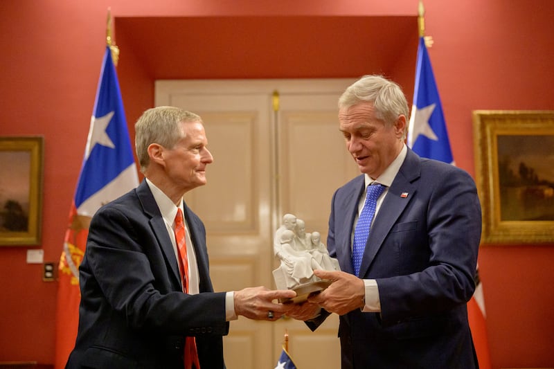 Elder David A. Bednar, du Collège des douze apôtres de l'Église de Jésus-Christ des Saints des Derniers Jours, offre au président chilien José Antonio Kast une statuette représentant une famille.
