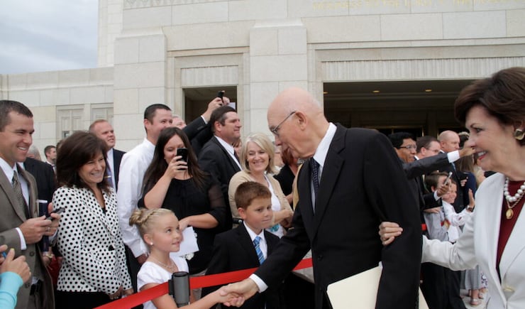 Elder Dallin H. Oaks of the Quorum of the Twelve shakes hands with cousins, Tayli Petersen, 9, and Payton Manning, 8, as he and Sister Kristen Oaks leave the Ogden Utah Temple after its rededication on Sept. 21.
