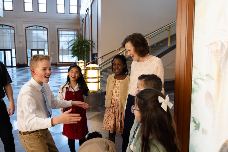 President Susan H. Porter talks with children in the Conference Center in Salt Lake City during a break in filming of the May 2026 Friend to Friend.