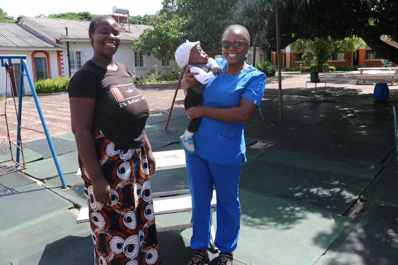 Un bébé d'un an retrouve un membre du personnel de l'USIN devant l'hôpital général Lewanika à Mongu, en Zambie. Le bébé Samuel est né prématurément en décembre 2024.