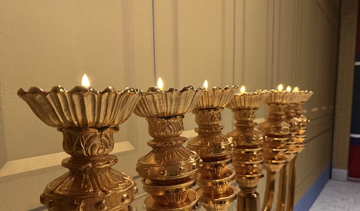 The lights of the menorah stand up against the South wall of the tabernacle replica in the Farmington Utah North Stake center, June 18, 2026.