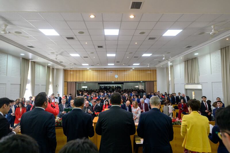 Elder David A. Bednar of the Quorum of the Twelve Apostles, second from the right, stand with the congregation during a meeting of the Colina Chile Stake conference in Santiago, Chile.